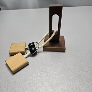 Wooden rope ring puzzle